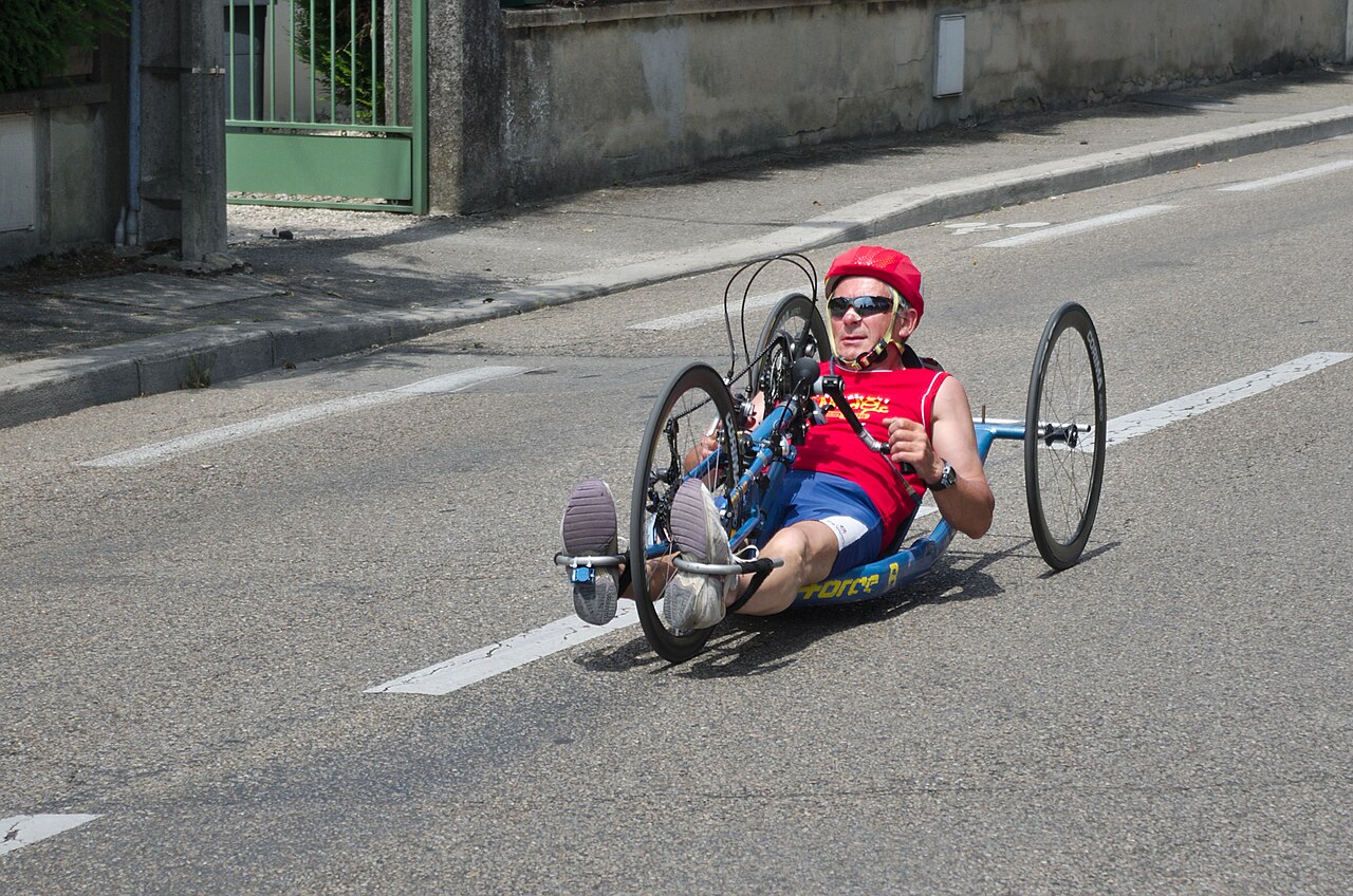 Corredor con casco rojo en hand bike