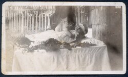 Retrato de niña muerta con corona de flores.