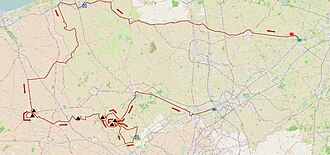 Ciclistas compitiendo bajo condiciones climáticas adversas en la Gante-Wevelgem 2015