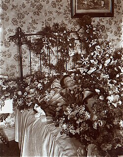Fotografía del siglo XIX de un niño fallecido con flores.