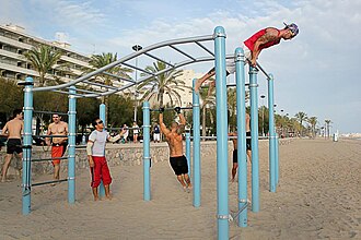 Atletas practicando ejercicios en barras en un parque urbano
