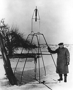 Robert Goddard junto a su primer cohete de combustible líquido