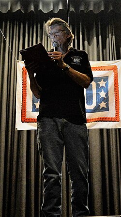 Stephen King leyendo fragmentos de su obra en un evento público.