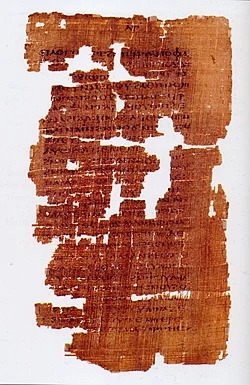 Página manuscrita del Evangelio de Judas sobre fondo oscuro.