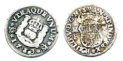 Moneda histórica española de medio real con la leyenda referida a las Indias