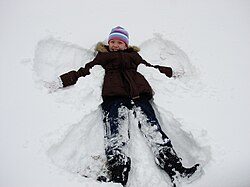 Niña haciendo un ángel de nieve