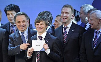 Andréi Arshavin y miembros del comité organizador ruso exhiben el cartel de la sede